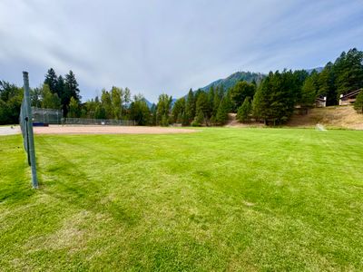 Ball fields at Enchantment Park in Leavenworth with Cascade peaks behind the outfield