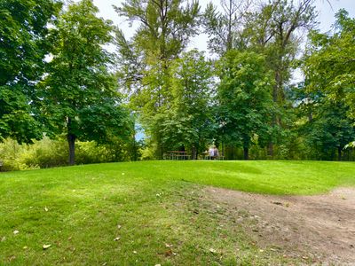 Shaded grass lawn with a picnic table at Waterfront Park