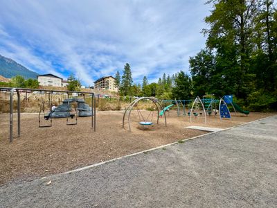 Playground with swings and climbers at Waterfront Park, Posthotel in the background