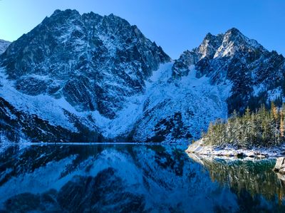 Golden larches above Colchuck Lake below Dragontail Peak in October