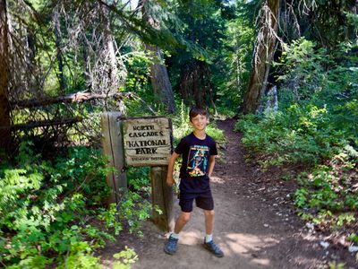 My son in front of the National Park sign