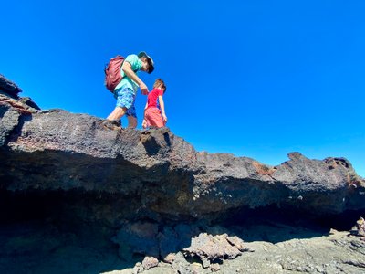 Grandpa and my son walking on lava rock